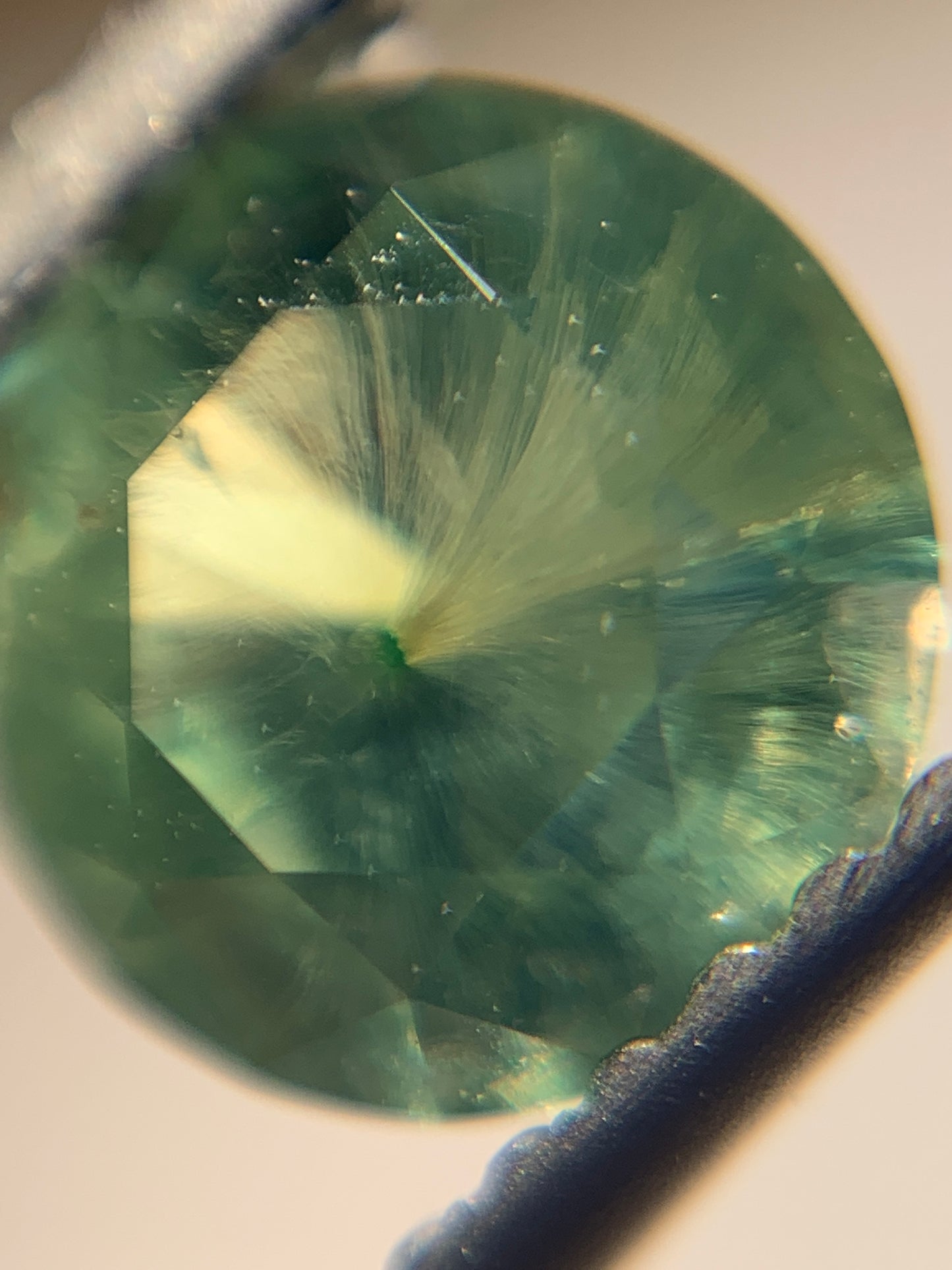 1.12cts Faceted Russian demantoid garnet with horsetail inclusion