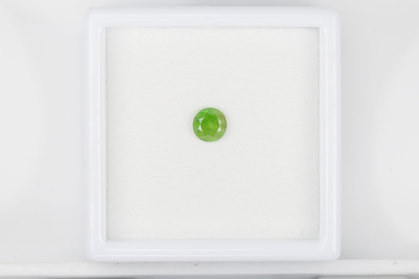 Vivid green faceted demantoid garnet, 0.6 ct