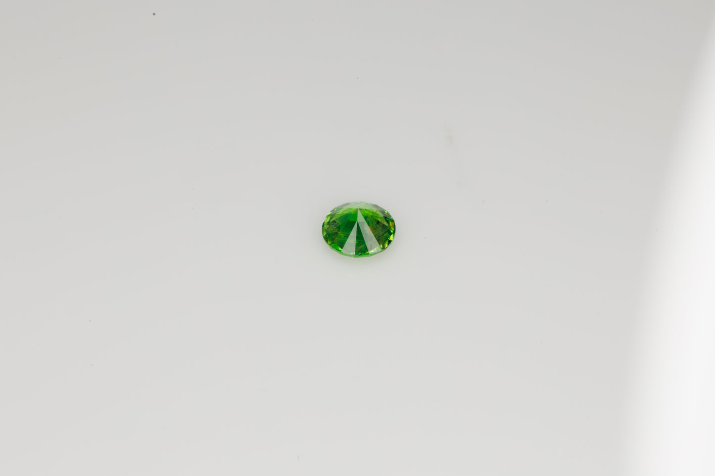 Faceted Russian demantoid garnet with byssolite inclusions, 0.29 ct