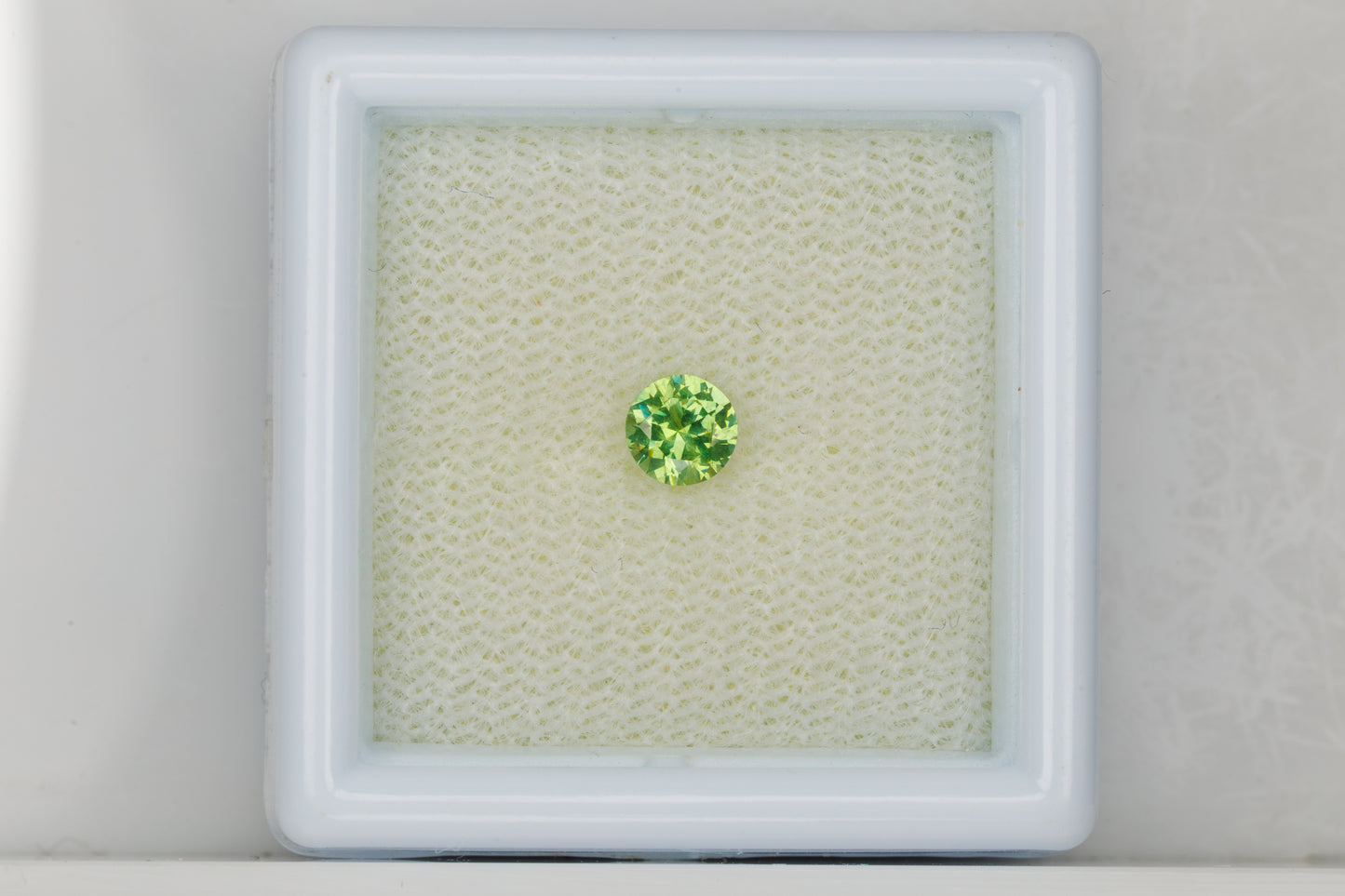 Faceted Russian demantoid garnet with byssolite inclusions, 0.29 ct
