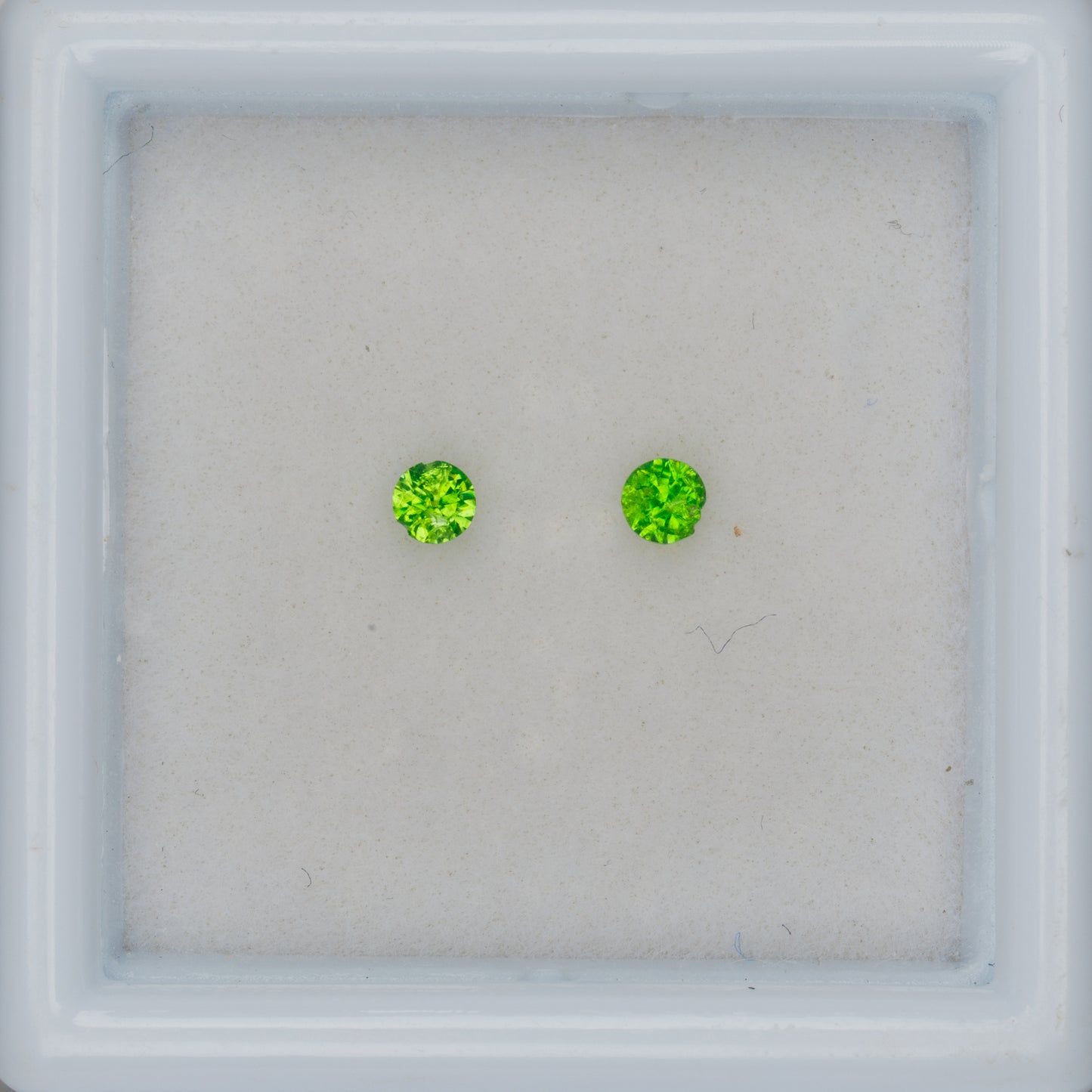 Faceted Russian demantoid garnet pair, 0.11 ct