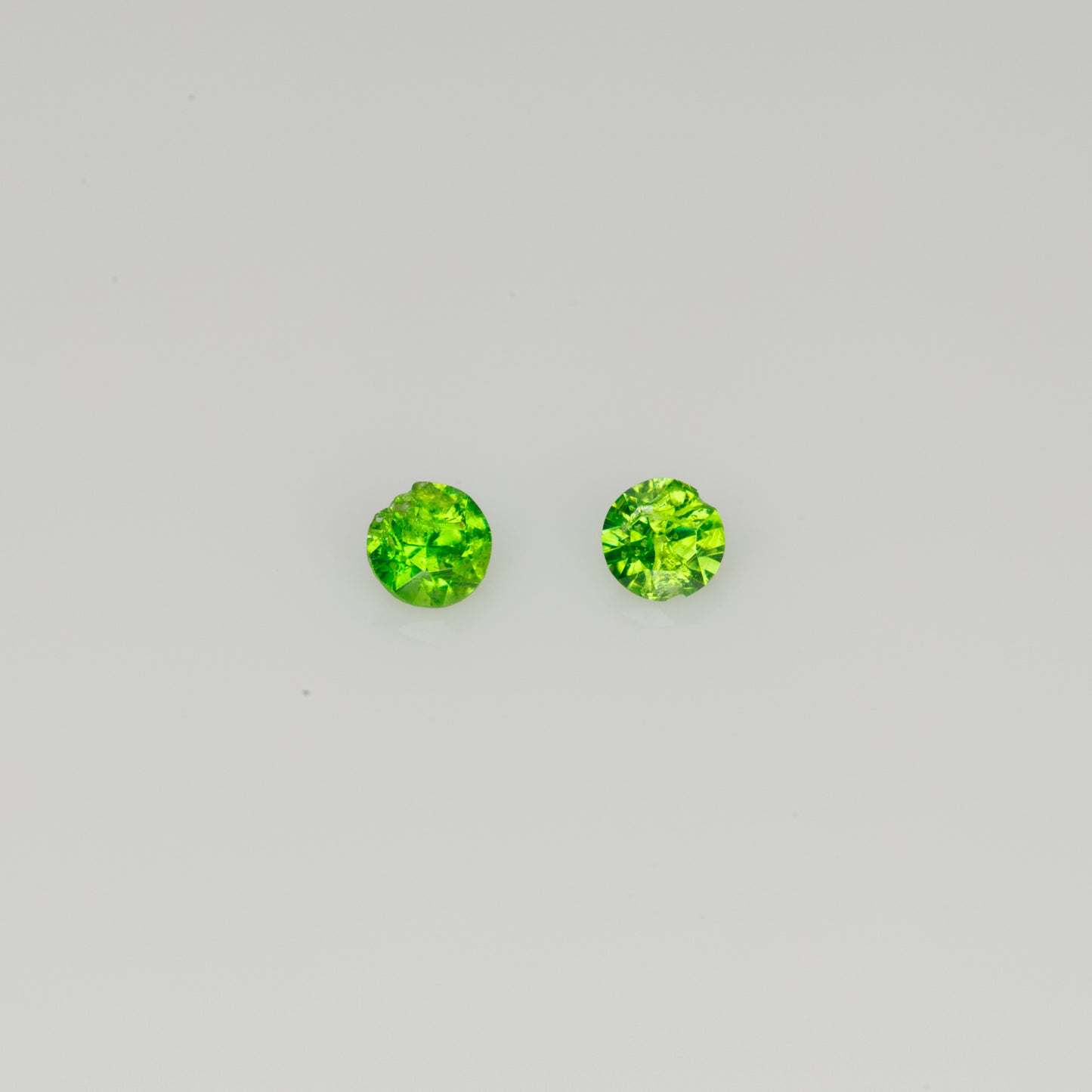 Faceted Russian demantoid garnet pair, 0.11 ct