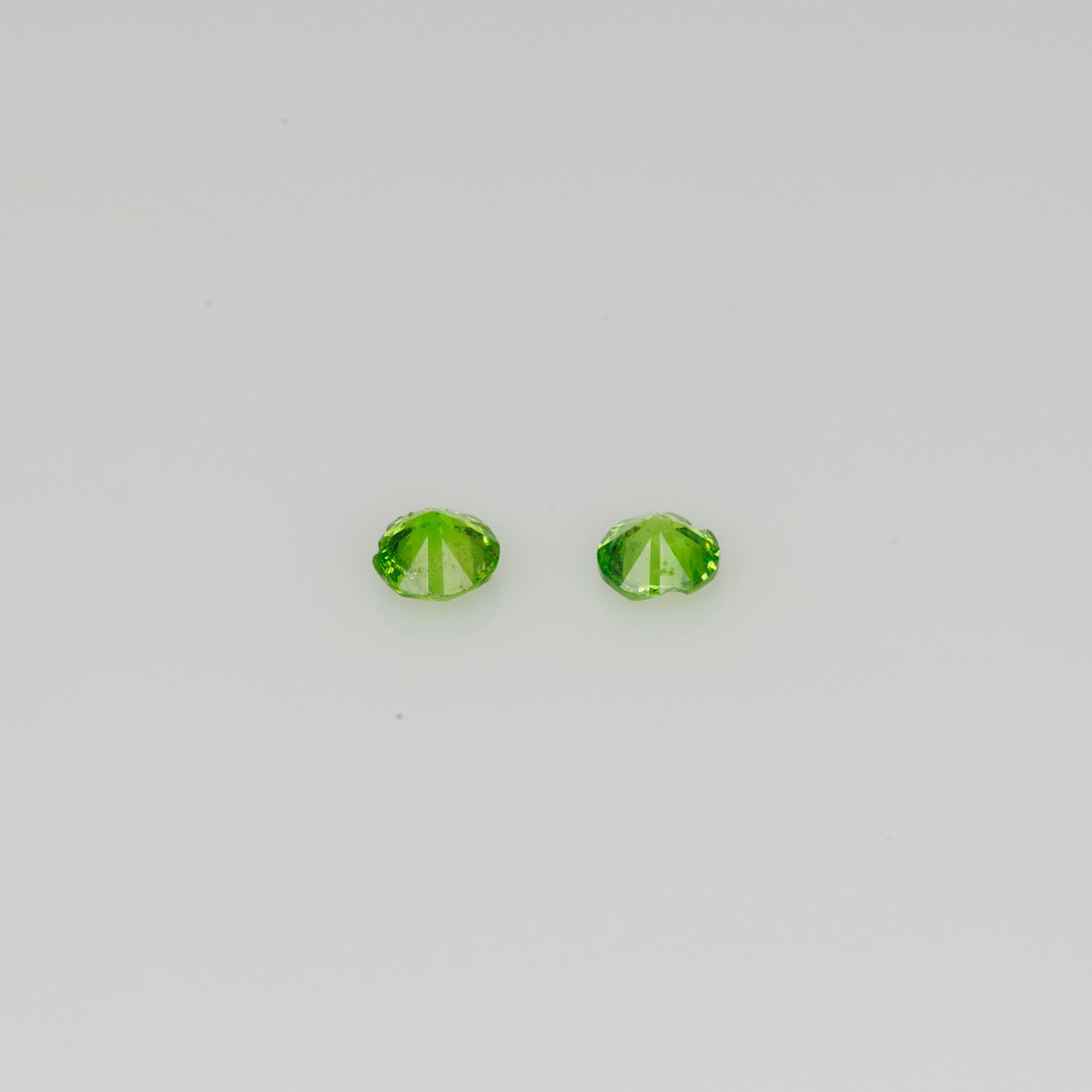 Faceted Russian demantoid garnet pair, 0.11 ct