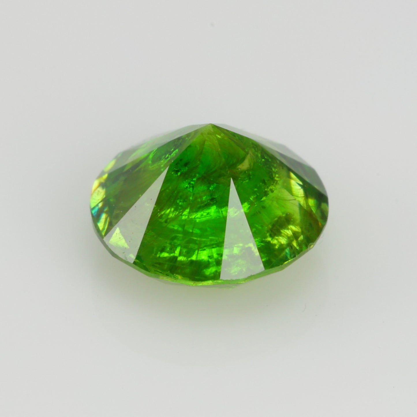 0.76 ct, Faceted Russian demantoid garnet with horsetail byssolite inclusions