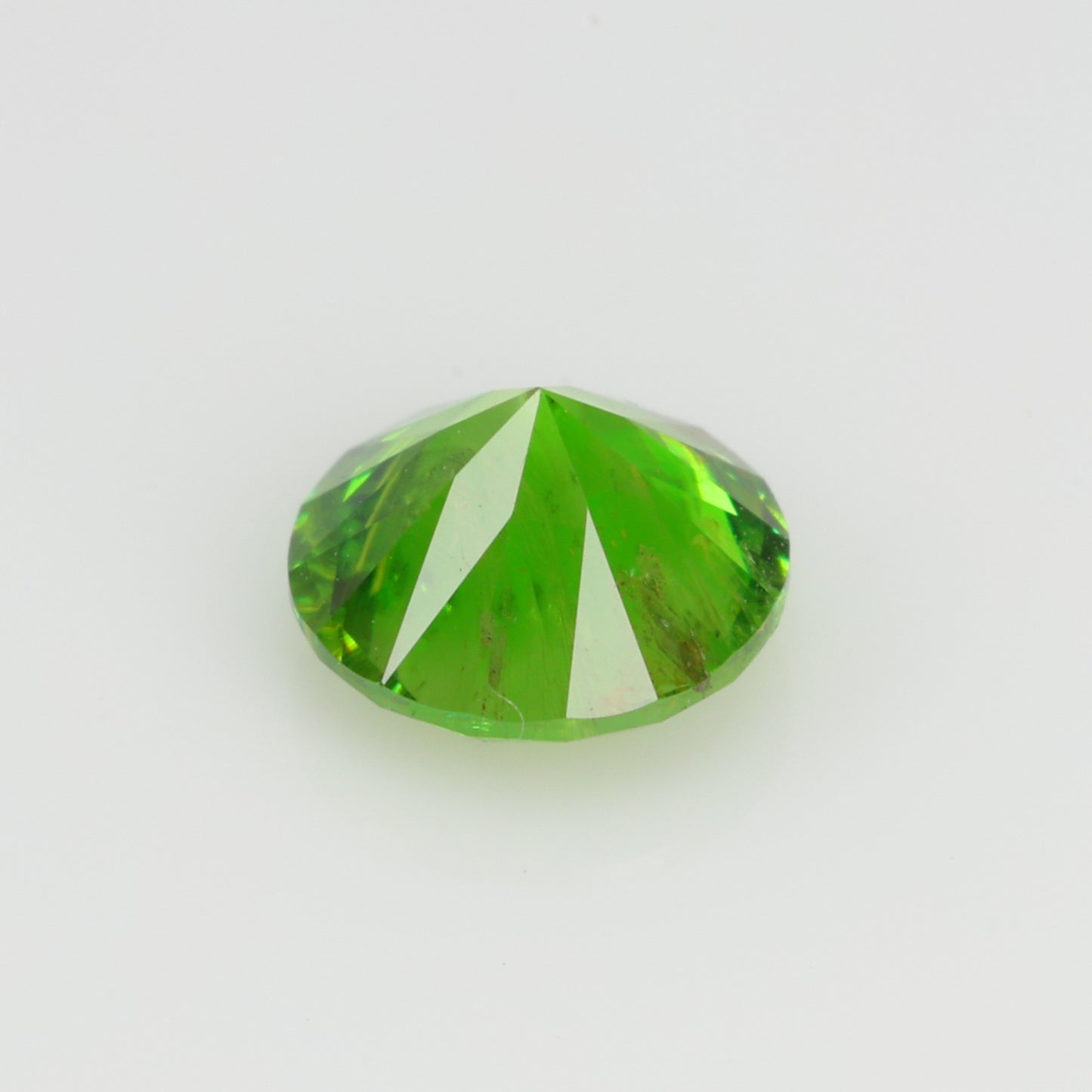 0.63 ct, Faceted Russian demantoid garnet with horsetail byssolite inclusions