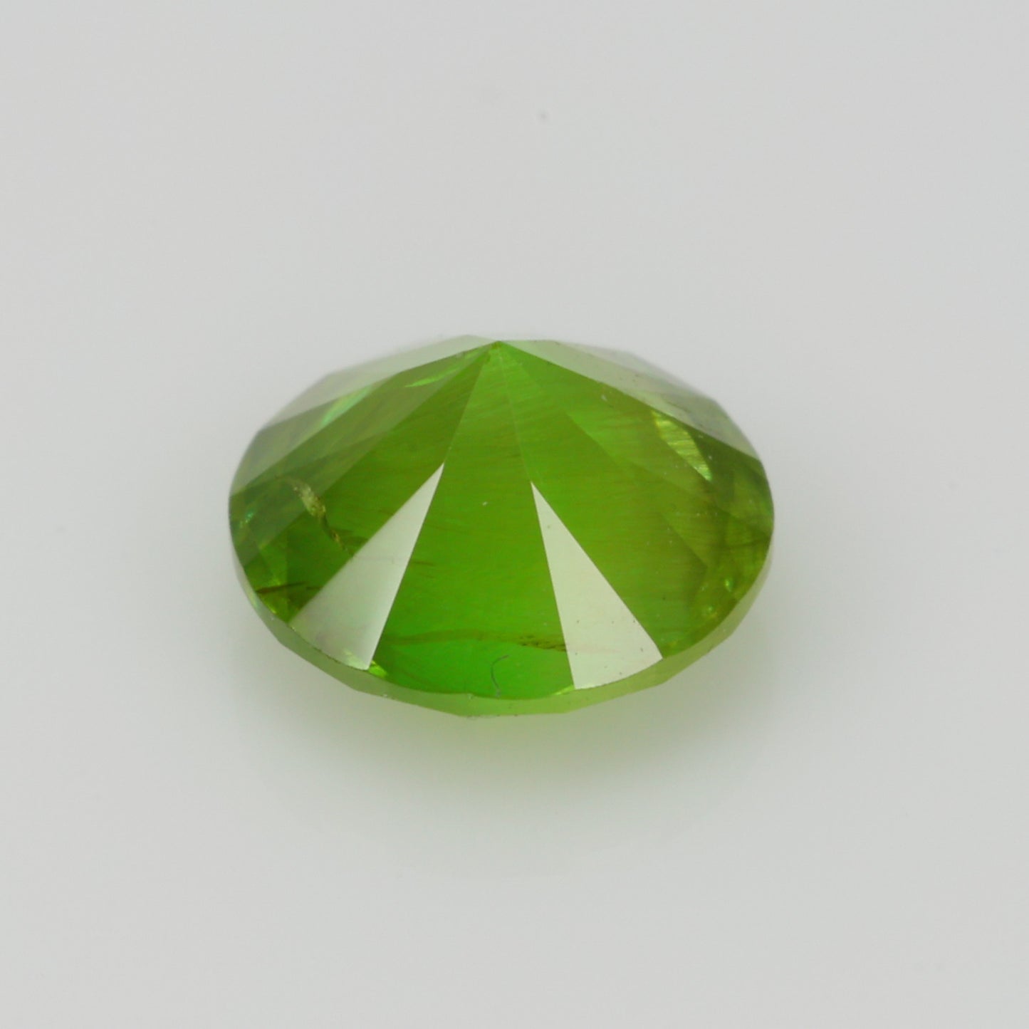 0.62 ct, Faceted Russian demantoid garnet with horsetail byssolite inclusions