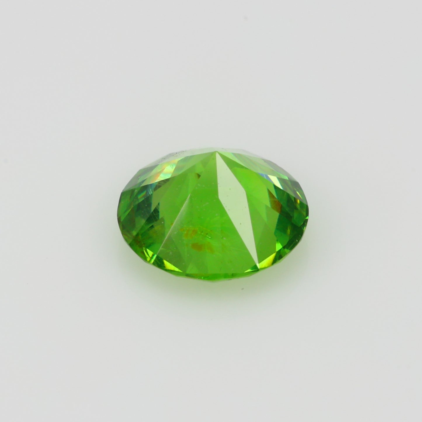 0.52 ct, Faceted Russian demantoid garnet with horsetail byssolite inclusions