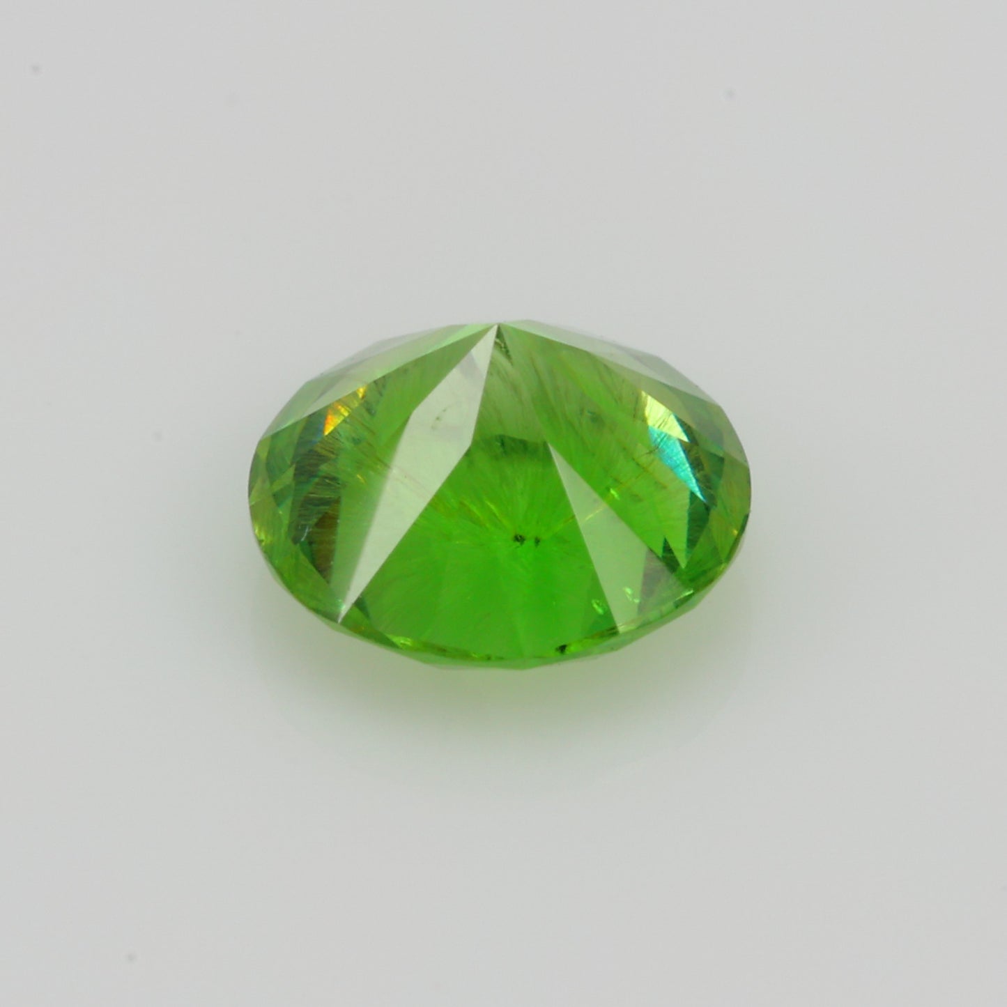 0.52 ct, Faceted Russian demantoid garnet with firework horsetail inclusions