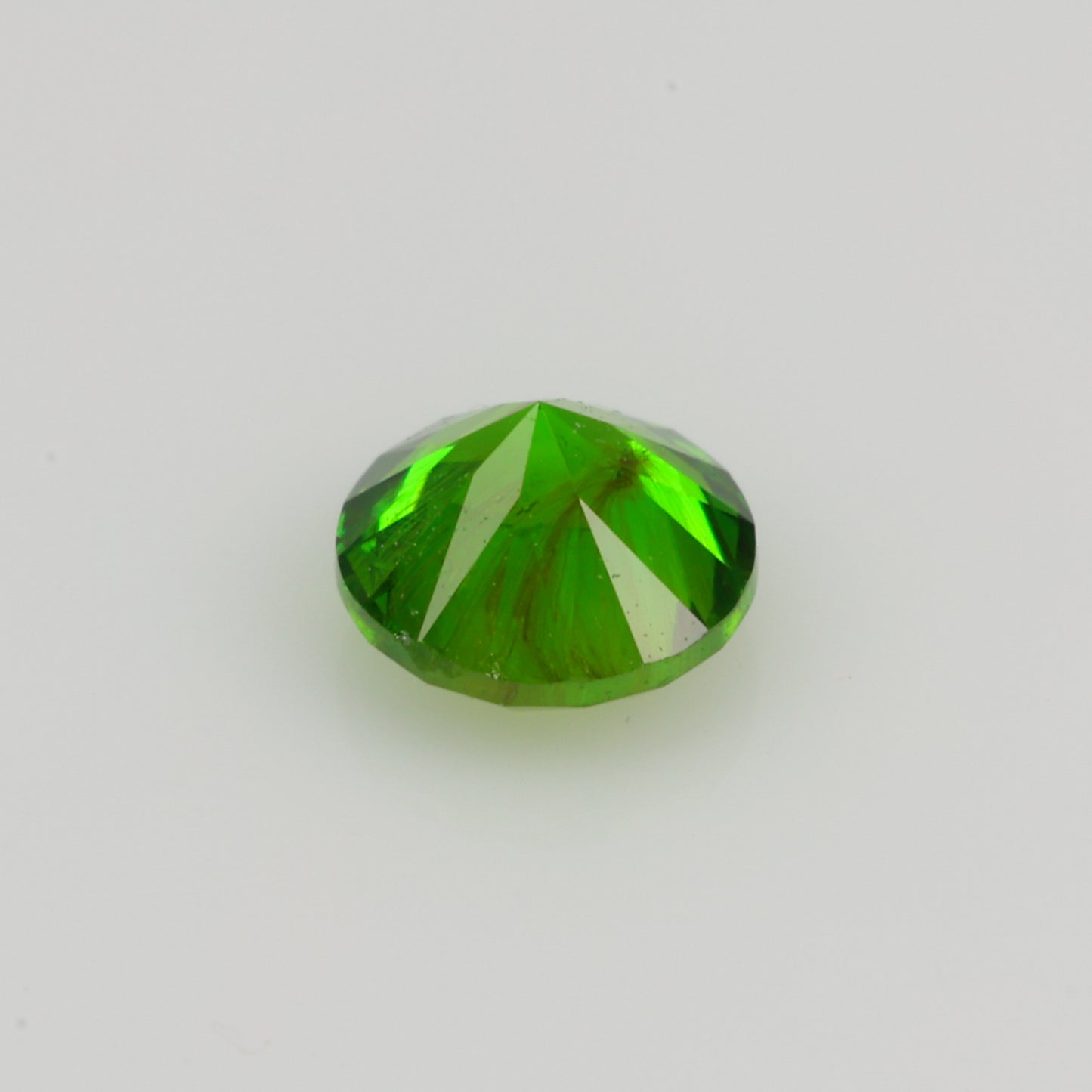 0.22 ct, Faceted Russian demantoid garnet high with horsetail inclusion