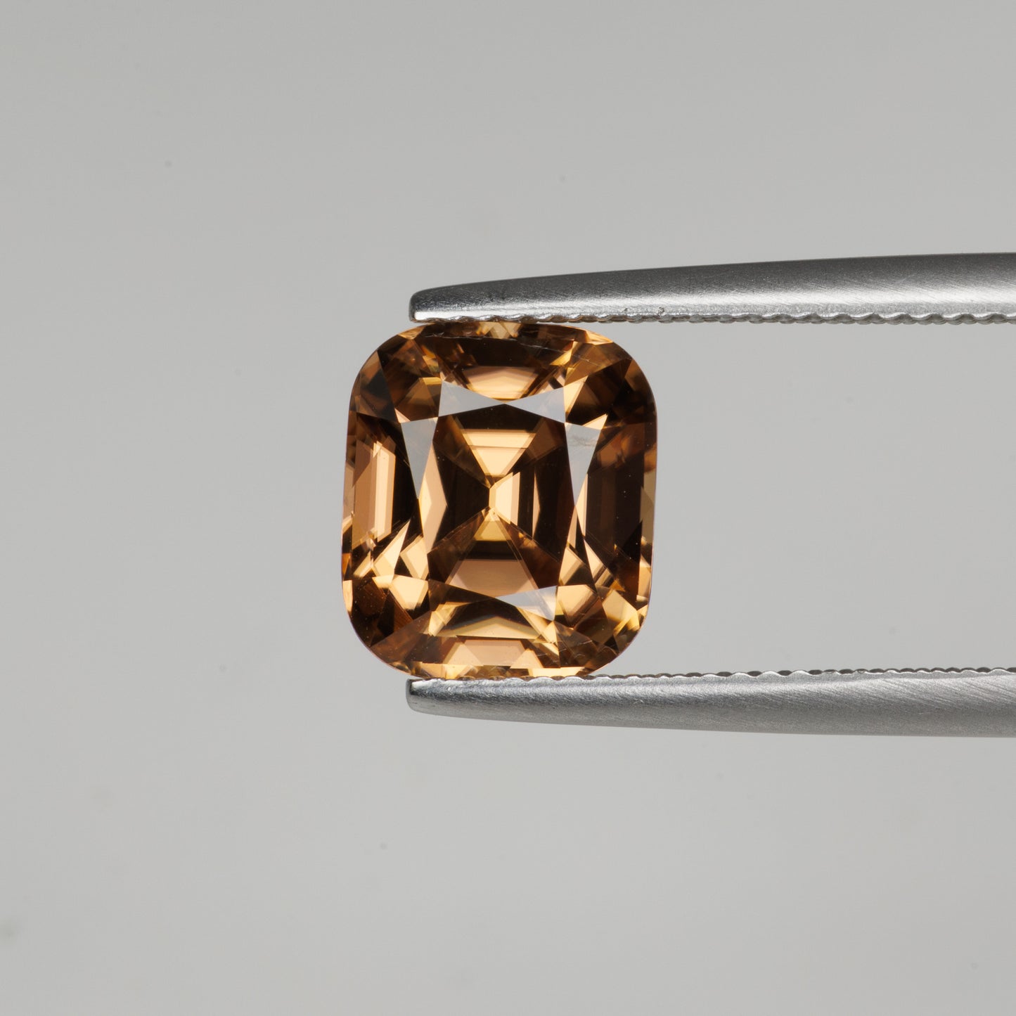 5.94 cts, Facted yellowish orange zircon cushion shape, perfect cut