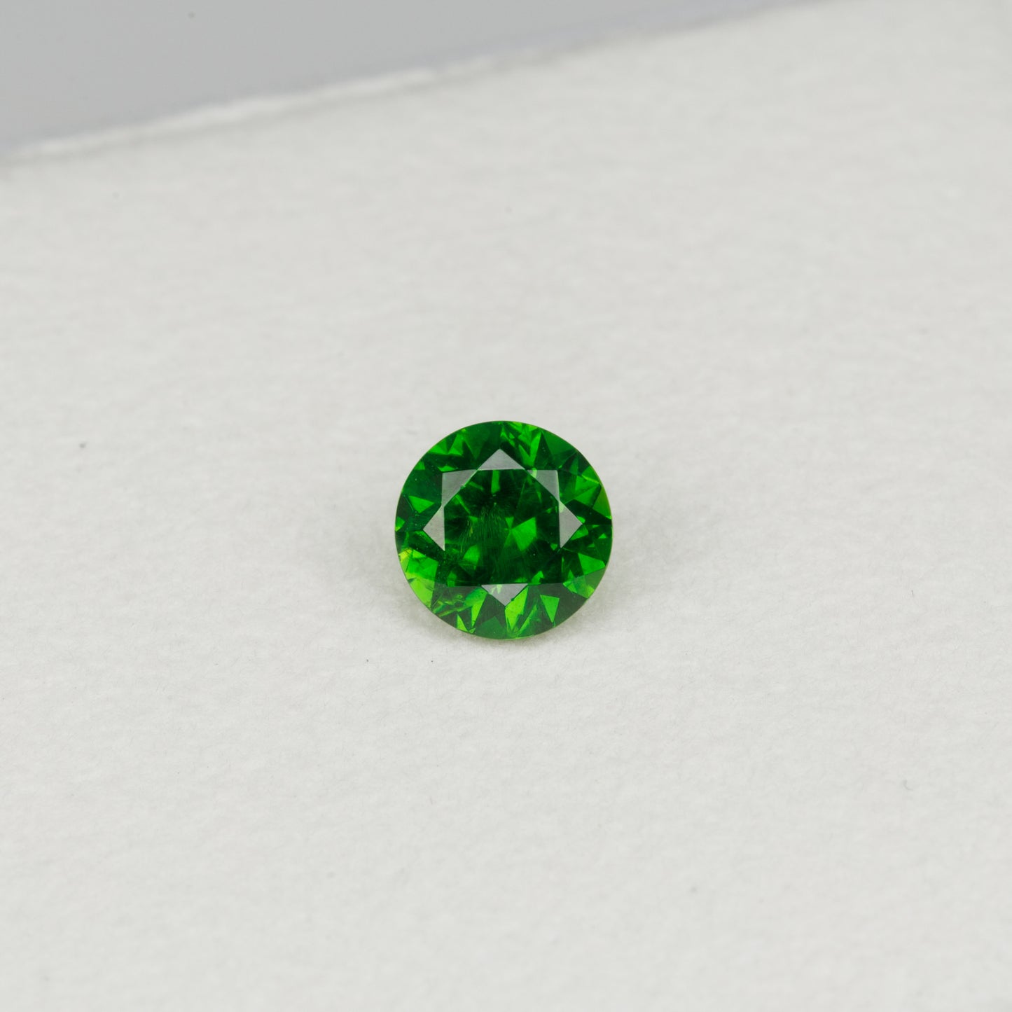 0.52cts, Faceted vivid green Rusisan demantoid garnet with horsetail inclusion