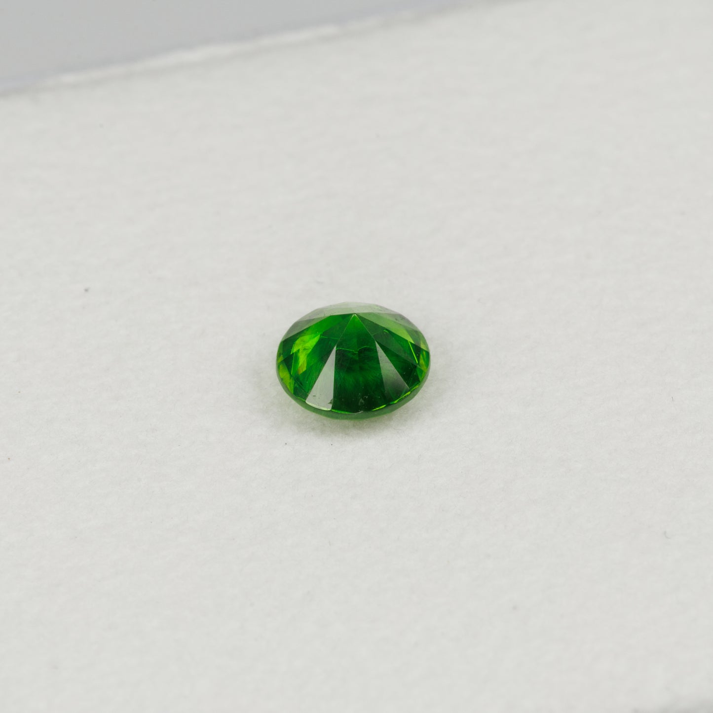 0.52cts, Faceted vivid green Rusisan demantoid garnet with horsetail inclusion