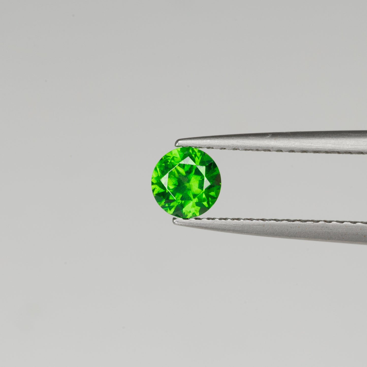 0.52cts, Faceted vivid green Rusisan demantoid garnet with horsetail inclusion