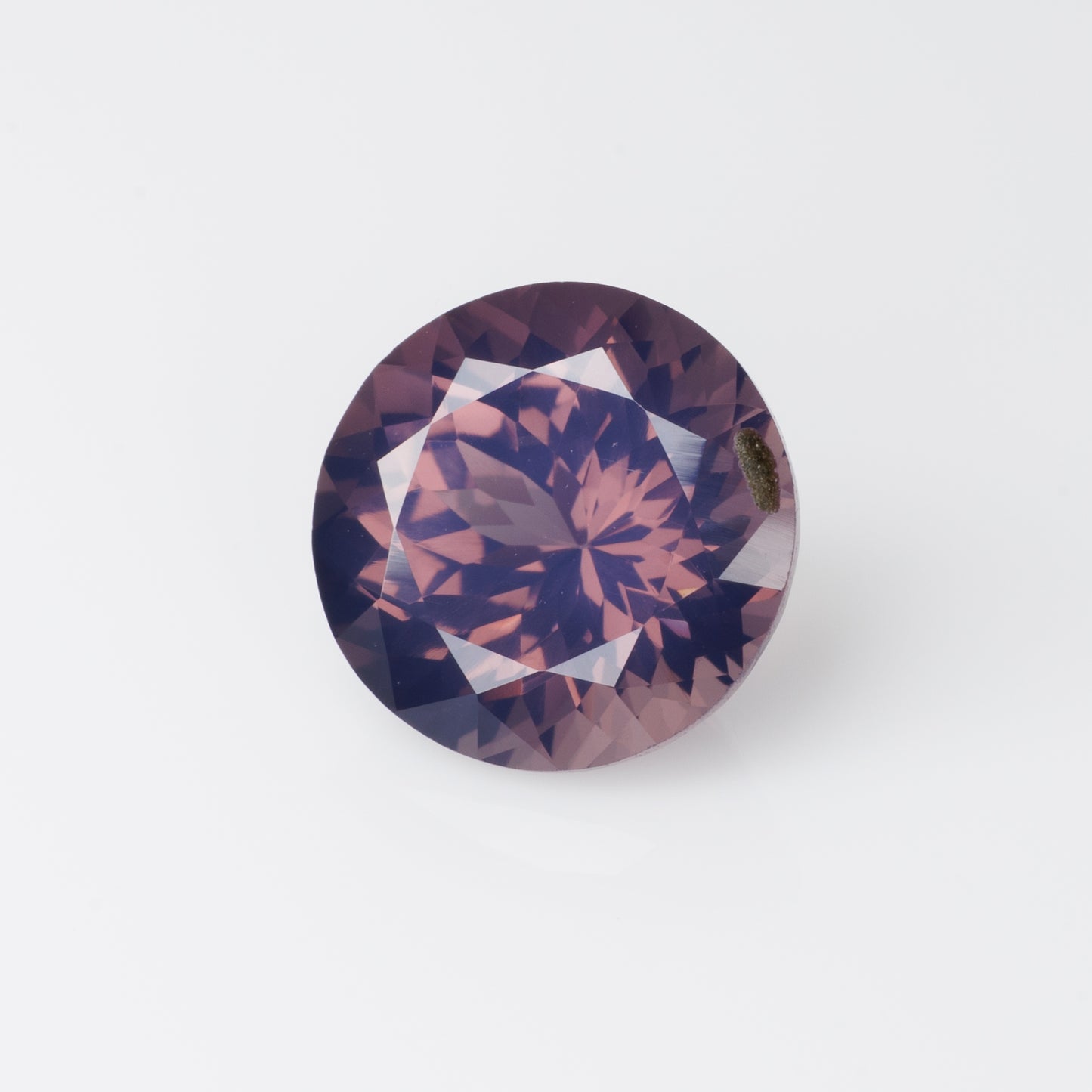 3.14 cts, Orangish purple milky faceted round spinel, very unusual color