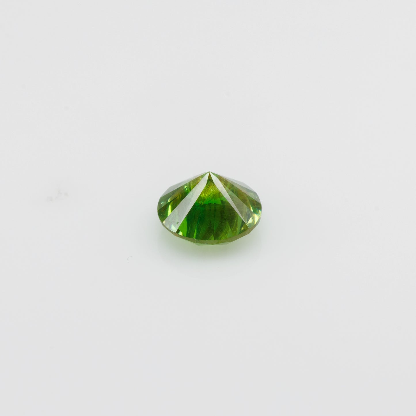 0.67 ct, Vivid green faceted Russian demantoid with byssolite inclusioms