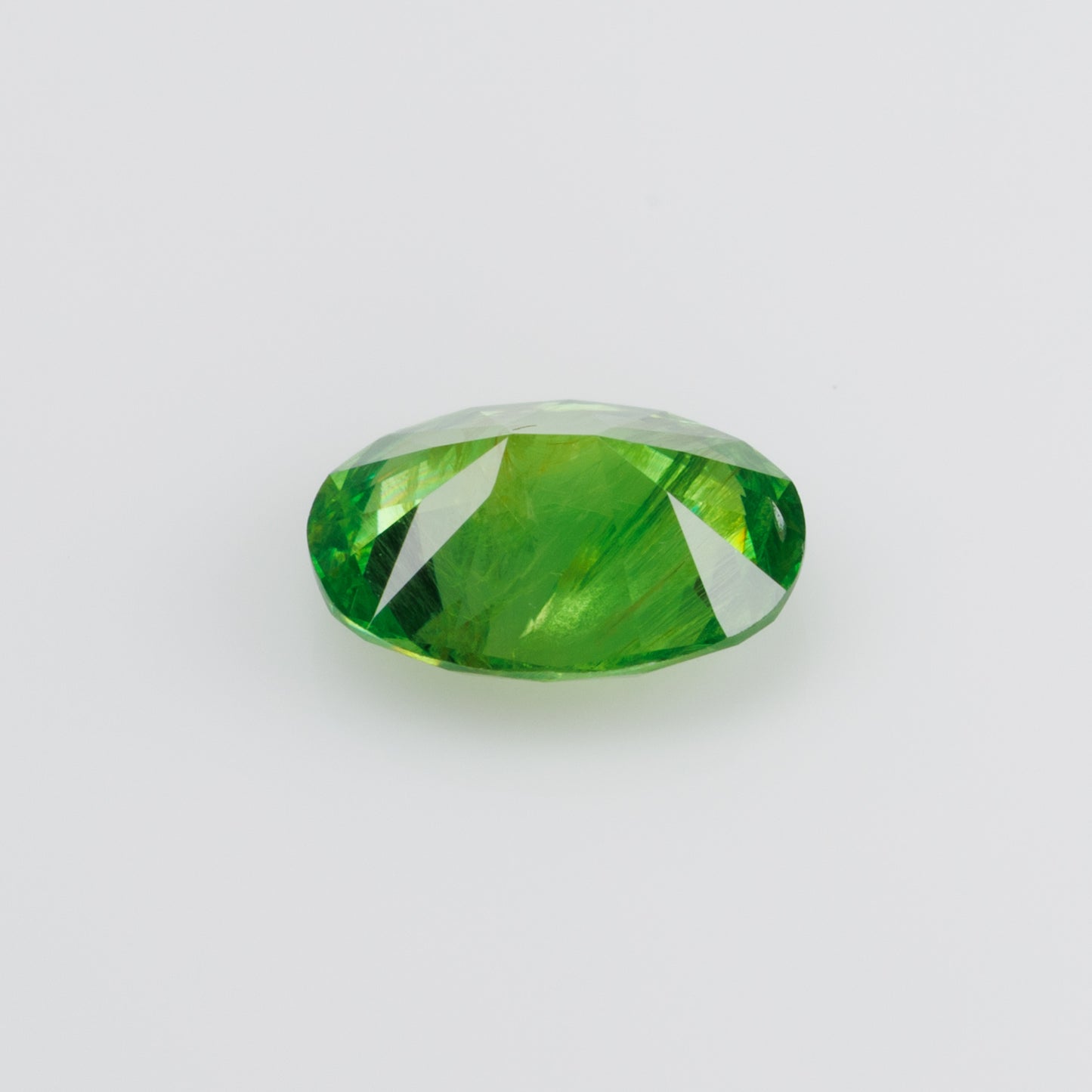 0.98 ct, Certified Russian faceted vivid apple green oval demantoid garnet with byssolite inclusions