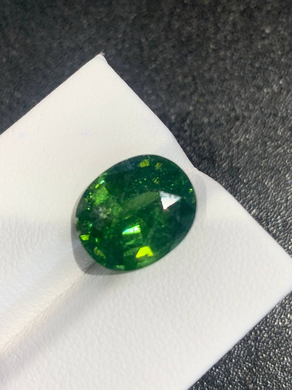 8 cts, Faceted vivid green zircon with amazing glow of the inclusions