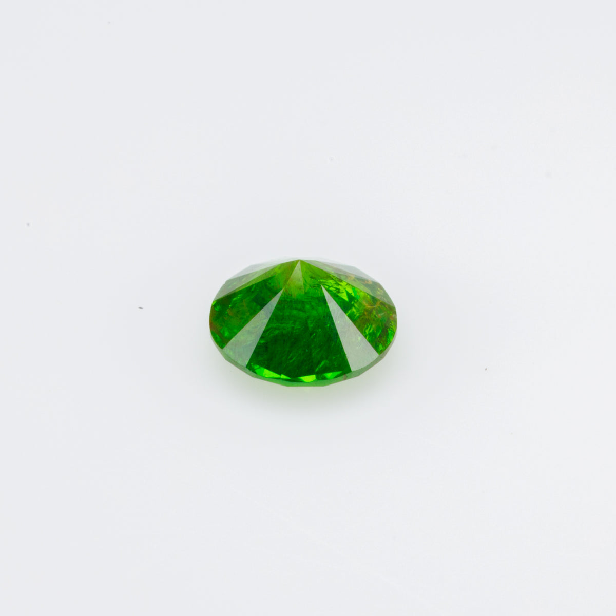 0.38 ct, Faceted Russian demantoid garnet with byssolite inclusions