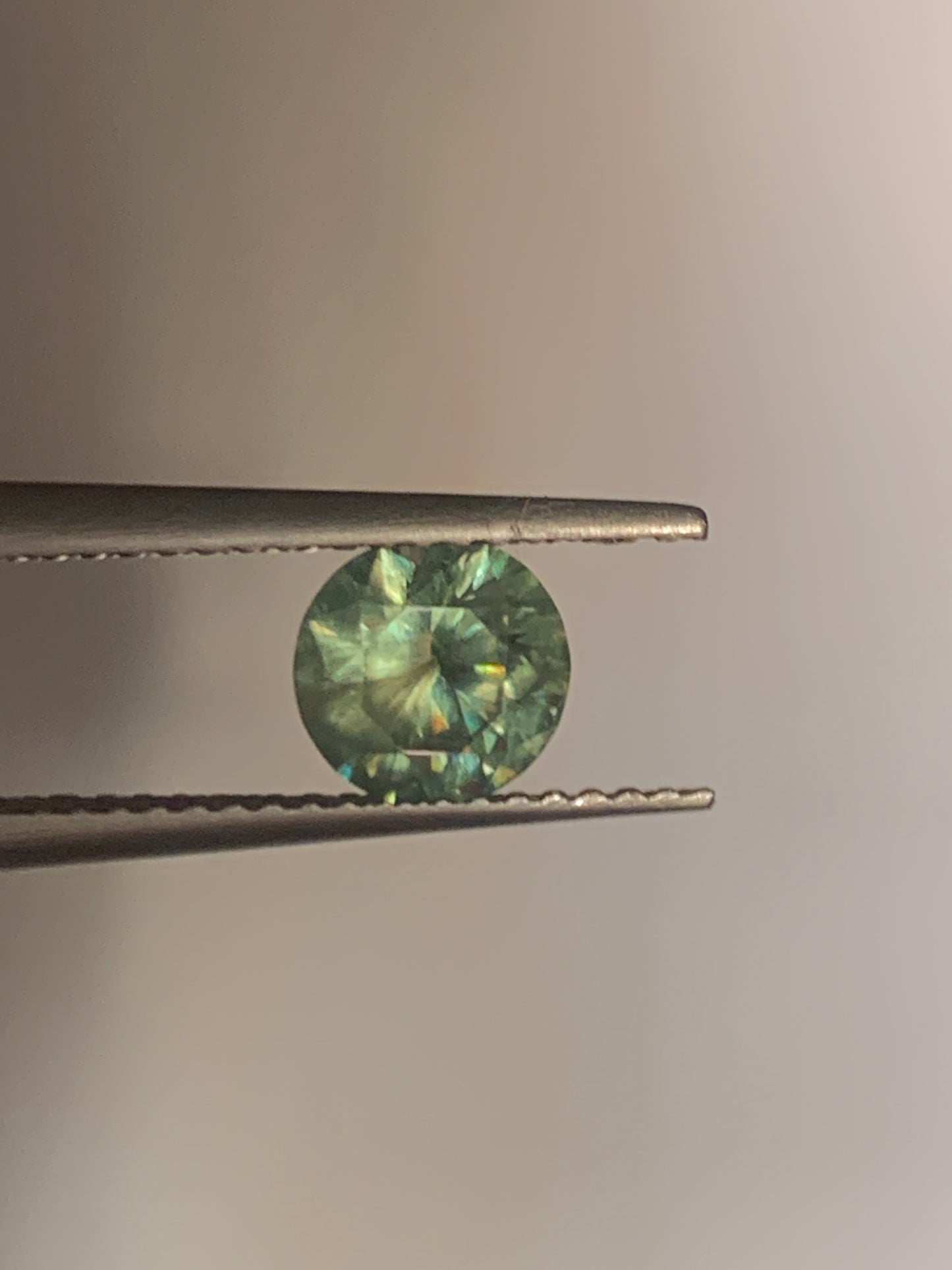 1.12cts Faceted Russian demantoid garnet with horsetail inclusion