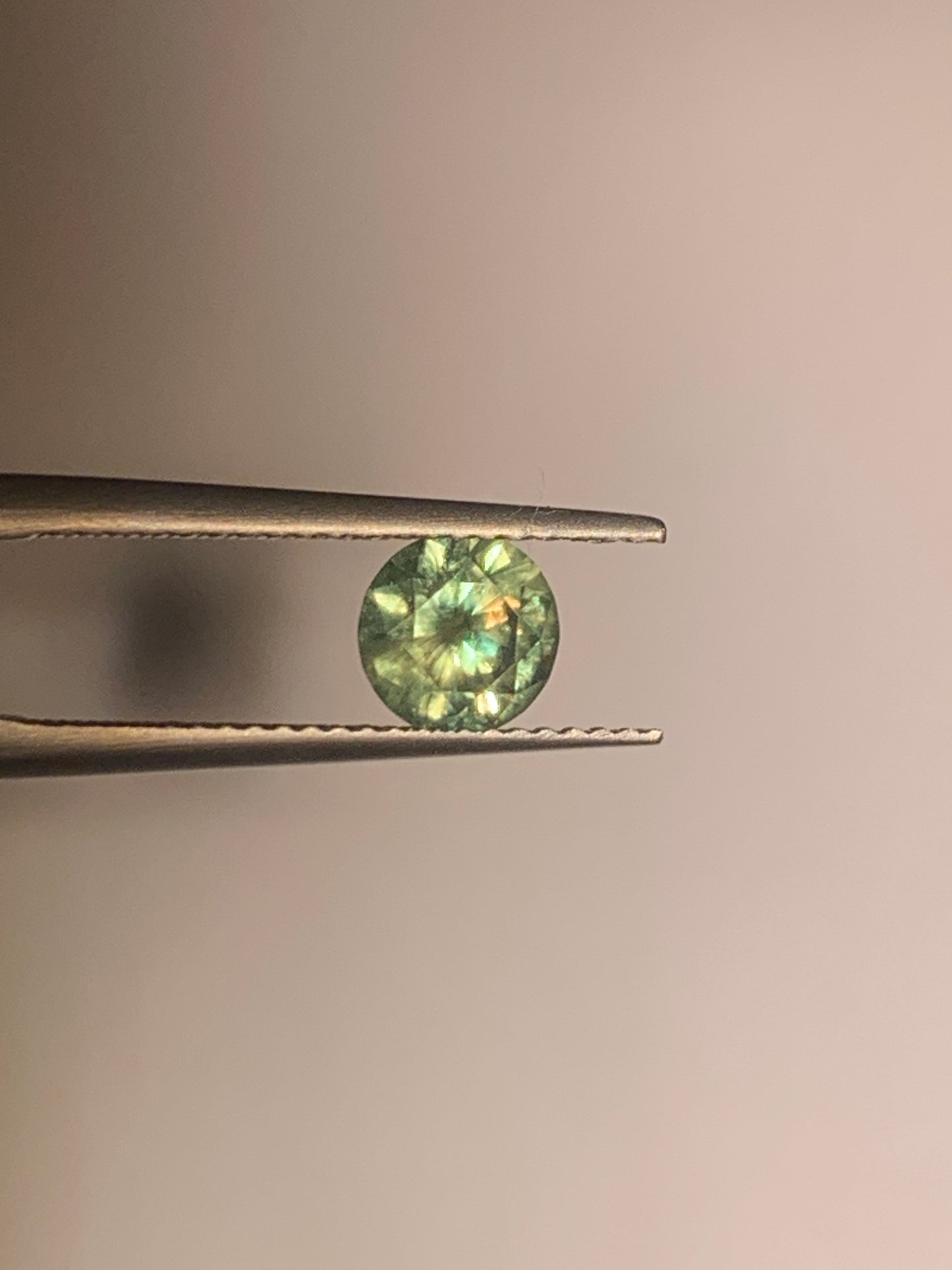 1.12cts Faceted Russian demantoid garnet with horsetail inclusion