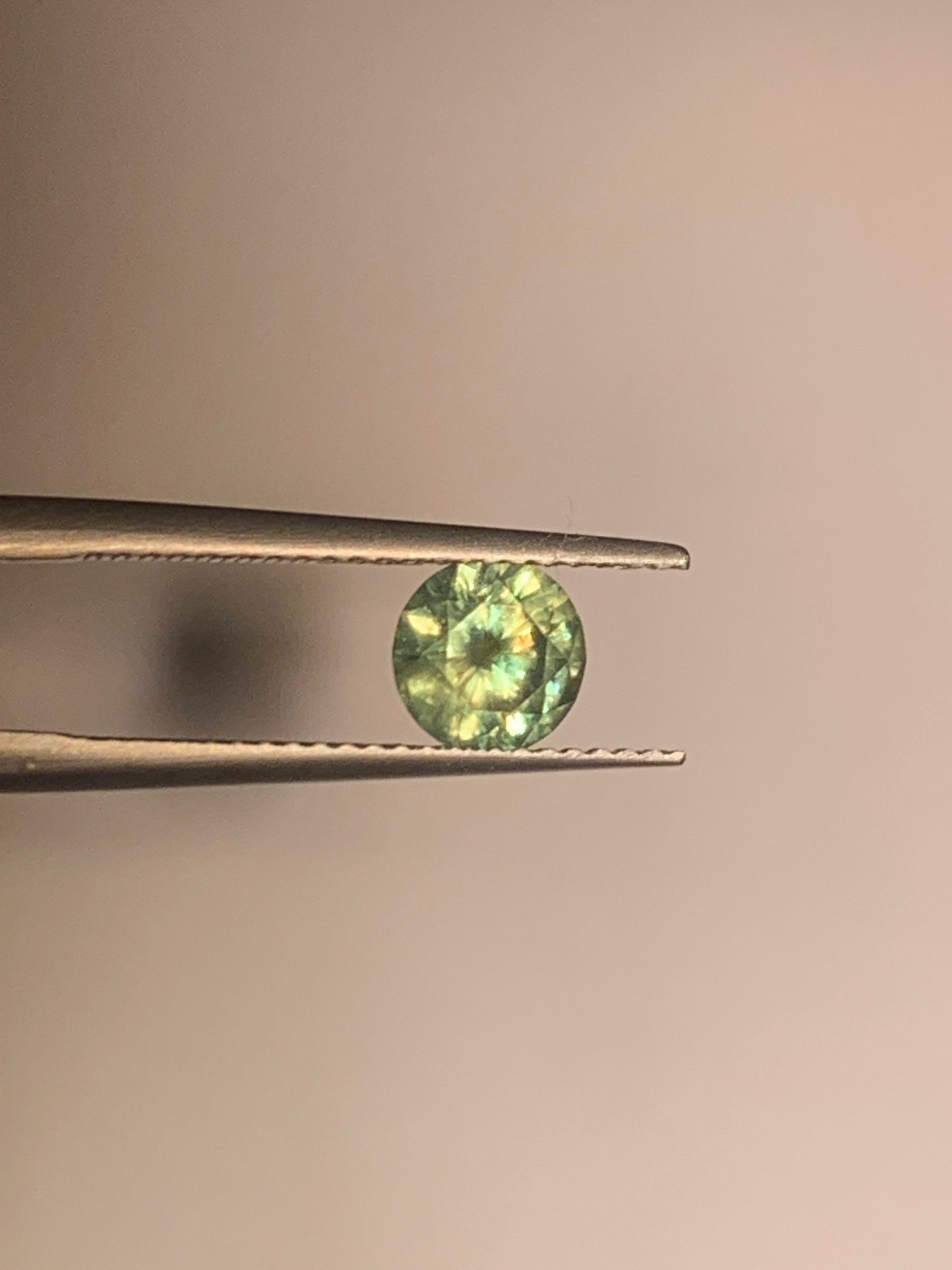 1.12cts Faceted Russian demantoid garnet with horsetail inclusion