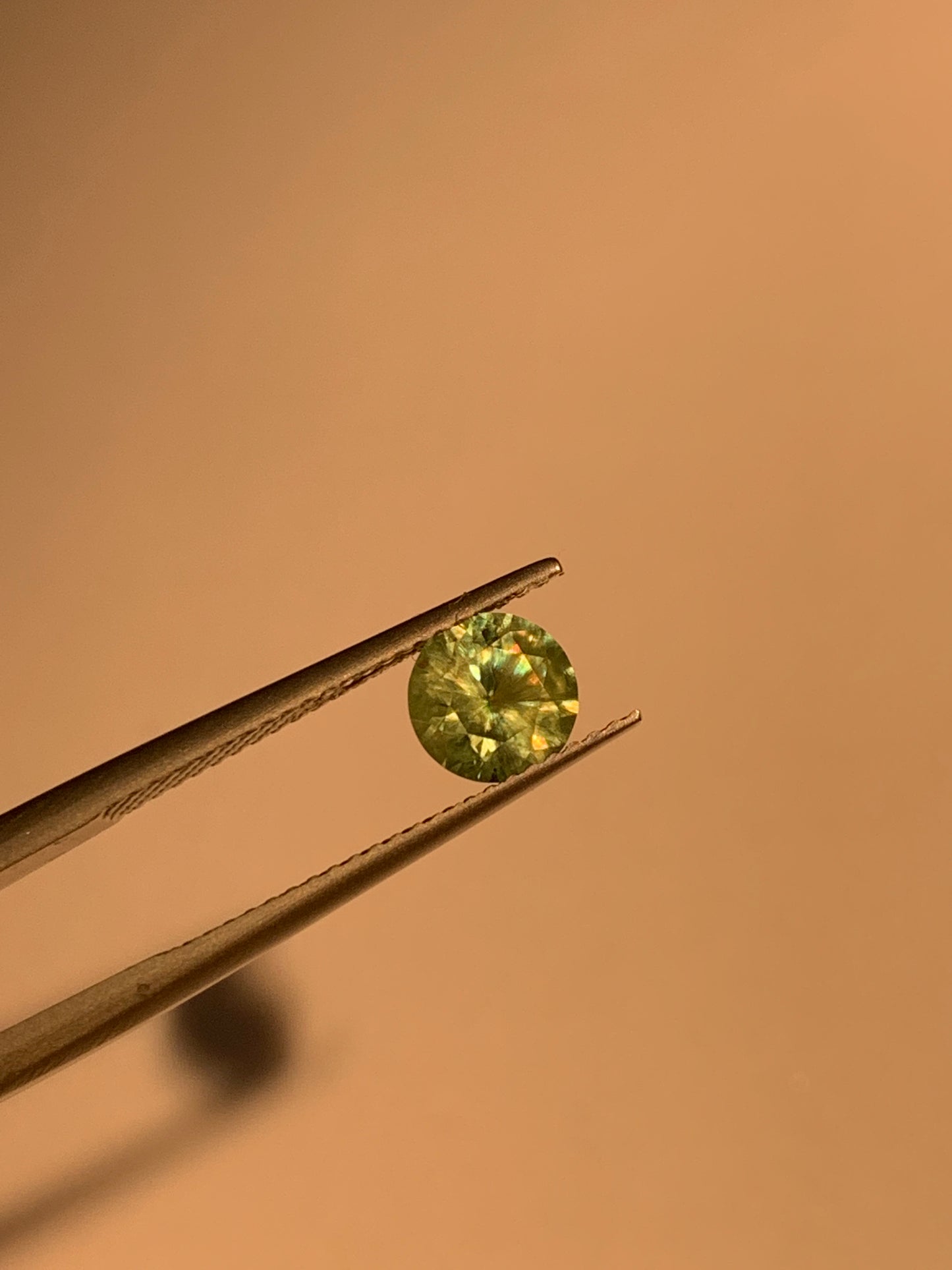 1.12cts Faceted Russian demantoid garnet with horsetail inclusion