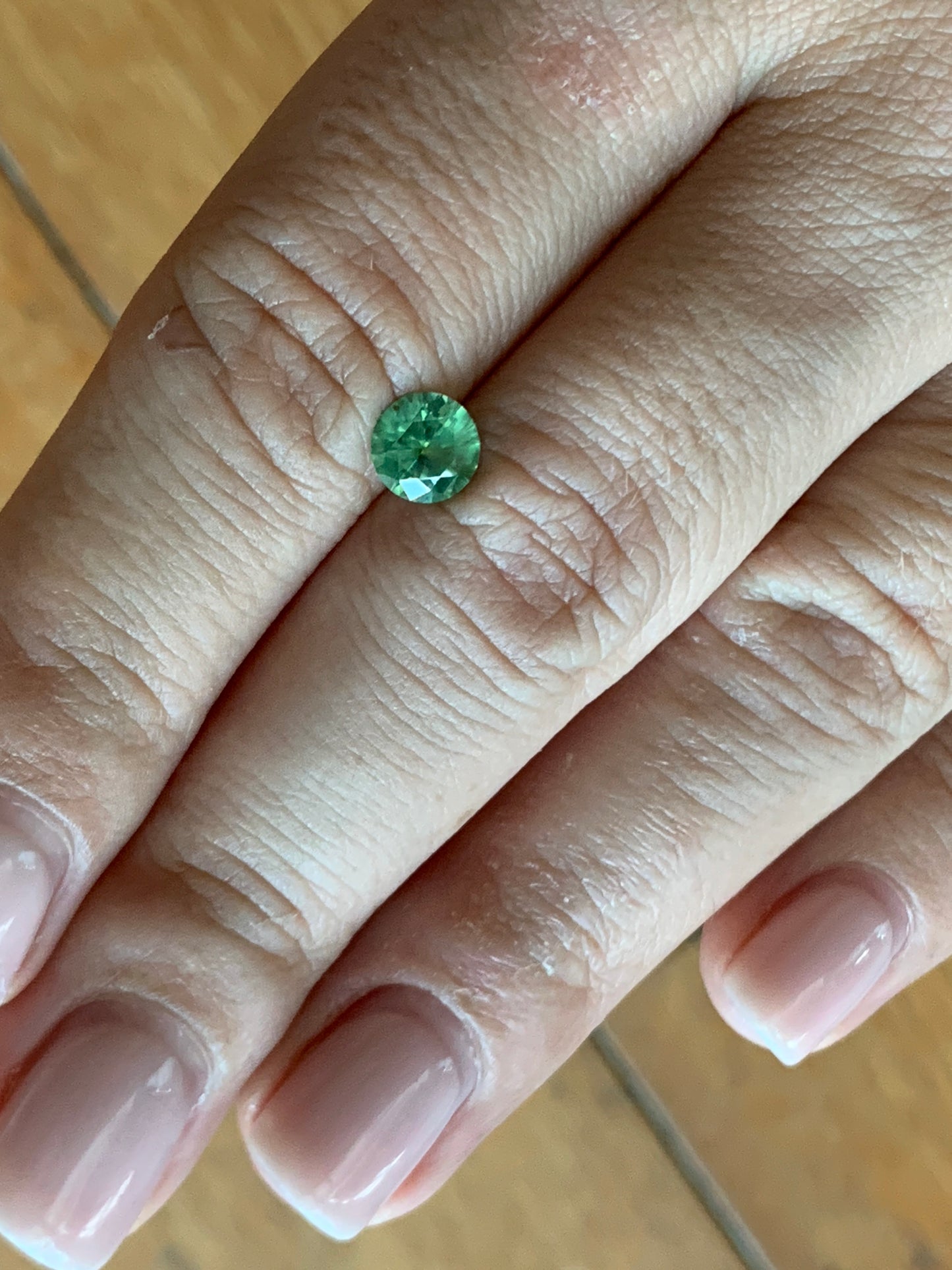 1.12cts Faceted Russian demantoid garnet with horsetail inclusion