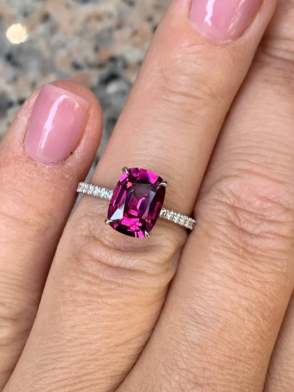 Golden ring with faceted rhodolite garnet