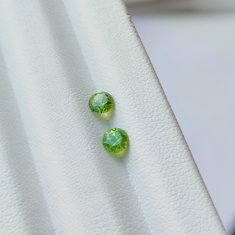 Faceted demantoid pair 0,64 ct