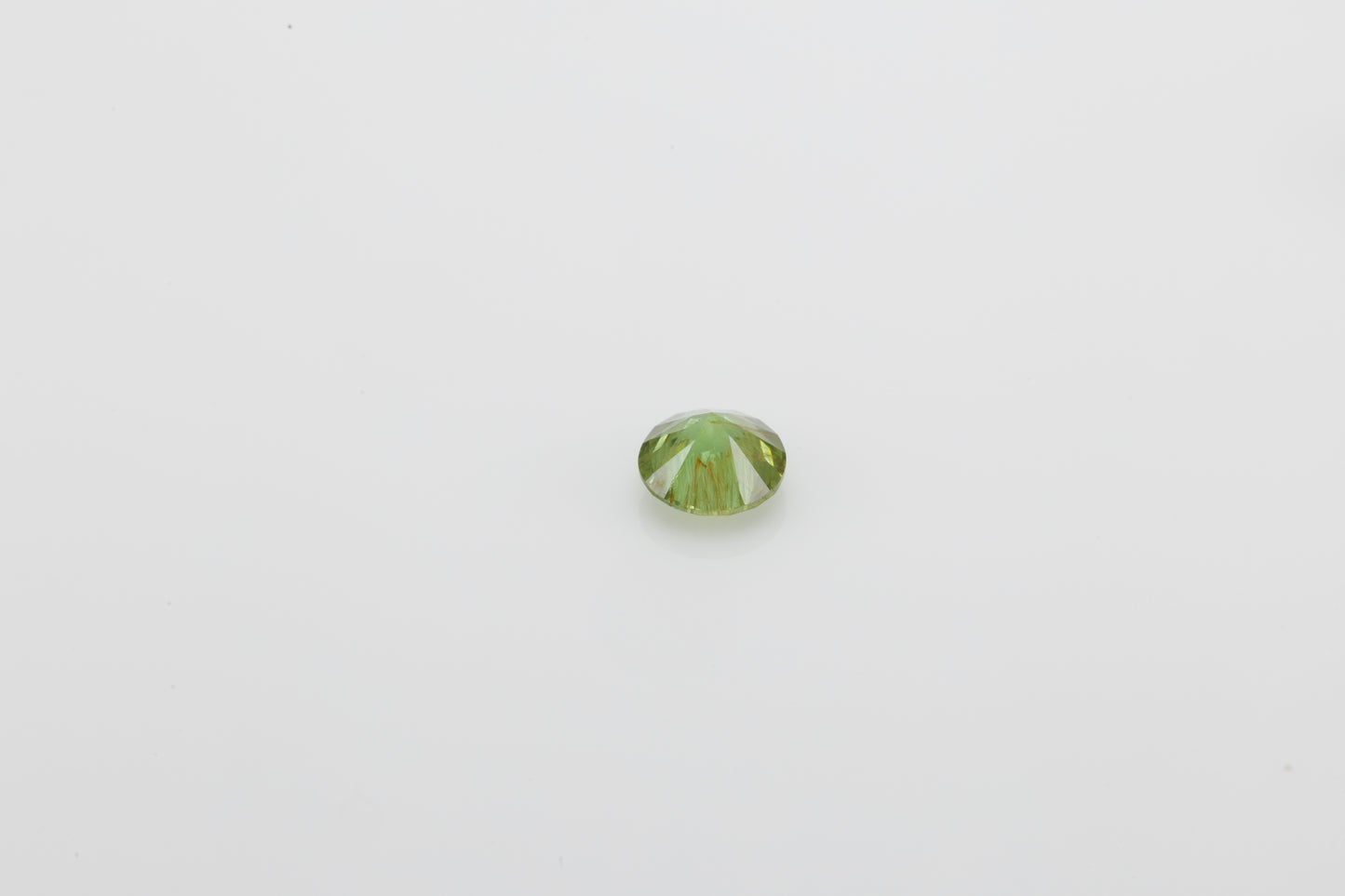 Yellowish green faceted demantoid garnet, 0.65 ct