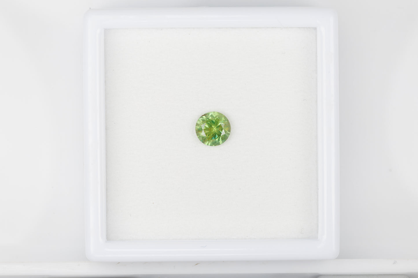 Yellowish green faceted demantoid garnet, 0.65 ct