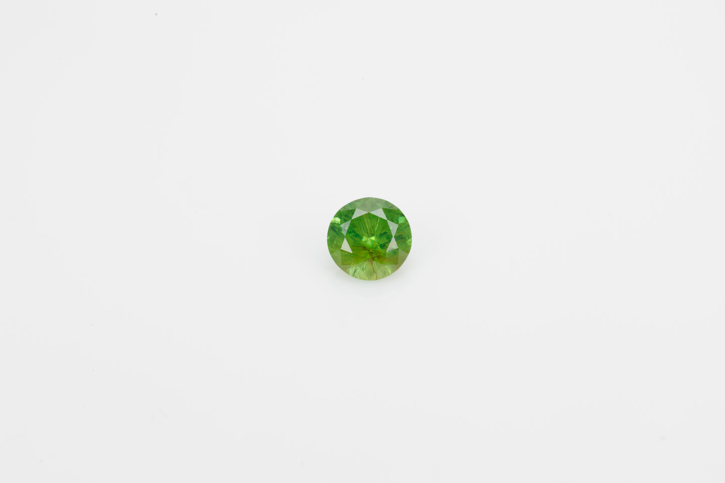 Facted demantoid garnet with obvious horsetail inclusion, 0.7 ct