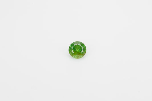 Facted demantoid garnet with obvious horsetail inclusion, 0.7 ct