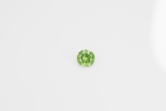 Facted demantoid garnet with obvious horsetail inclusion, 0.53 ct