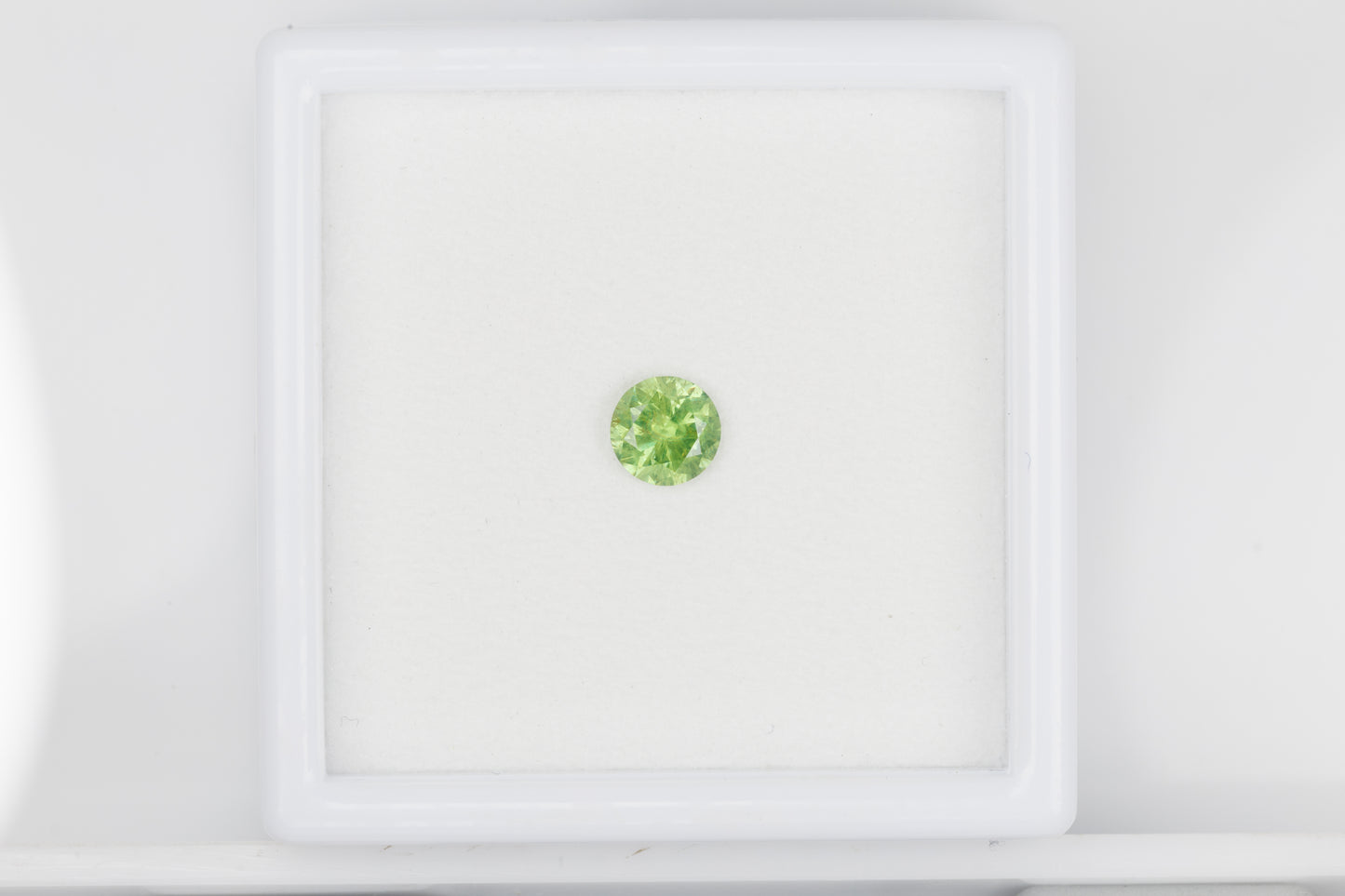 Facted demantoid garnet with obvious horsetail inclusion, 0.53 ct