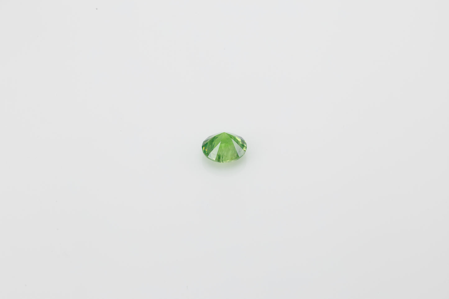 Faceted demantoid garnet with good color and dispersion, 0.46 ct