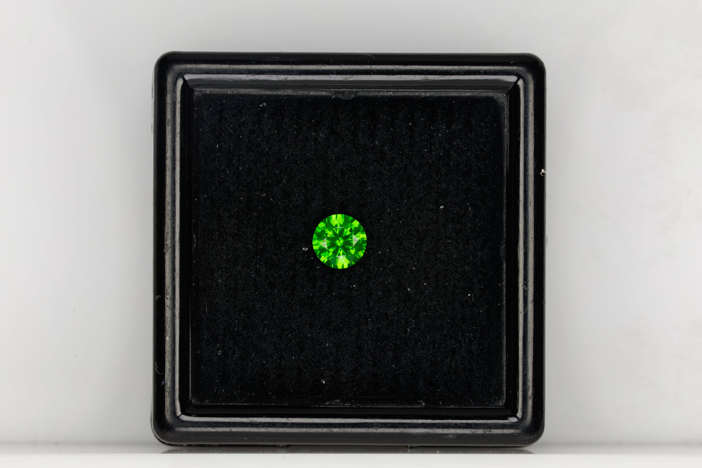 Vivid green faceted Russian demantoid garnet with byssolite inclusions, 0.32 ct