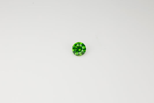 Vivid green faceted Russian demantoid garnet with byssolite inclusions, 0.32 ct