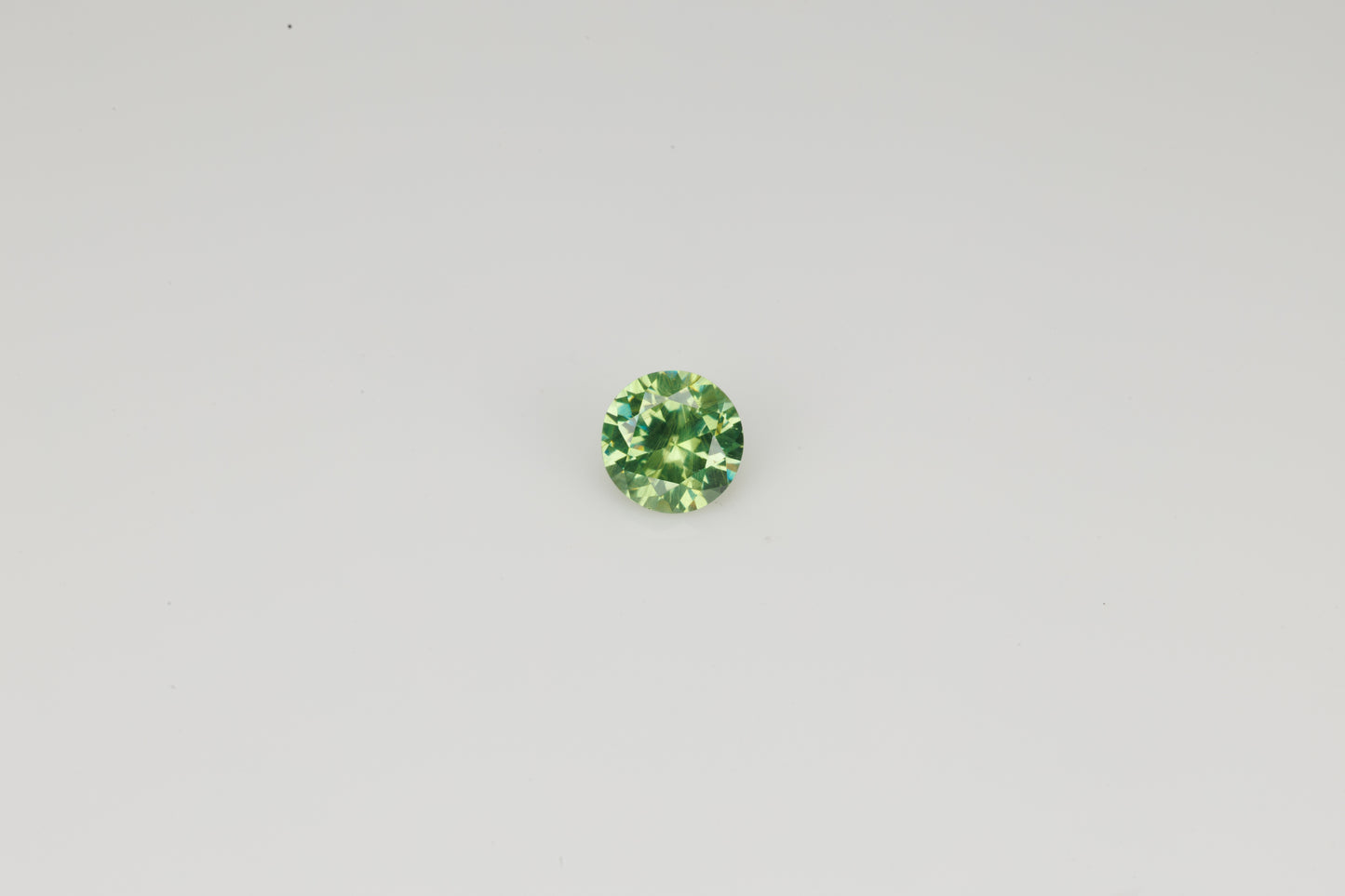 Faceted Russian demantoid garnet with byssolite inclusions, 0.29 ct