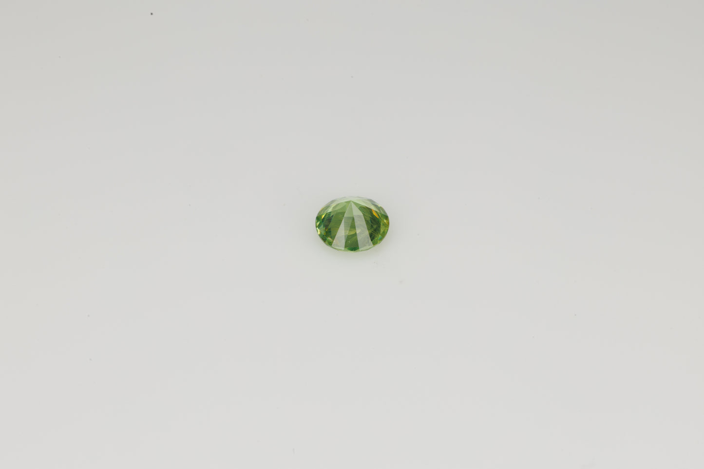 Faceted Russian demantoid garnet with byssolite inclusions, 0.29 ct