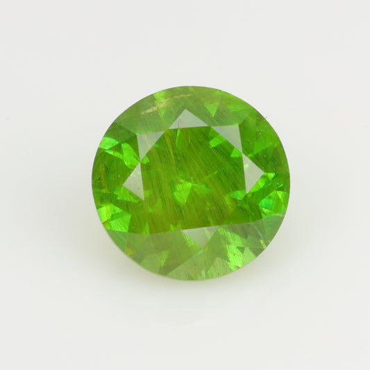 0.62 ct, Faceted Russian demantoid garnet with horsetail byssolite inclusions