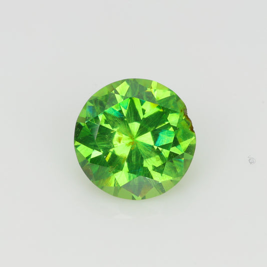 0.52 ct, Faceted Russian demantoid garnet with horsetail byssolite inclusions
