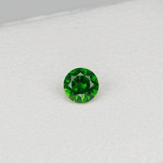 0.52cts, Faceted vivid green Rusisan demantoid garnet with horsetail inclusion