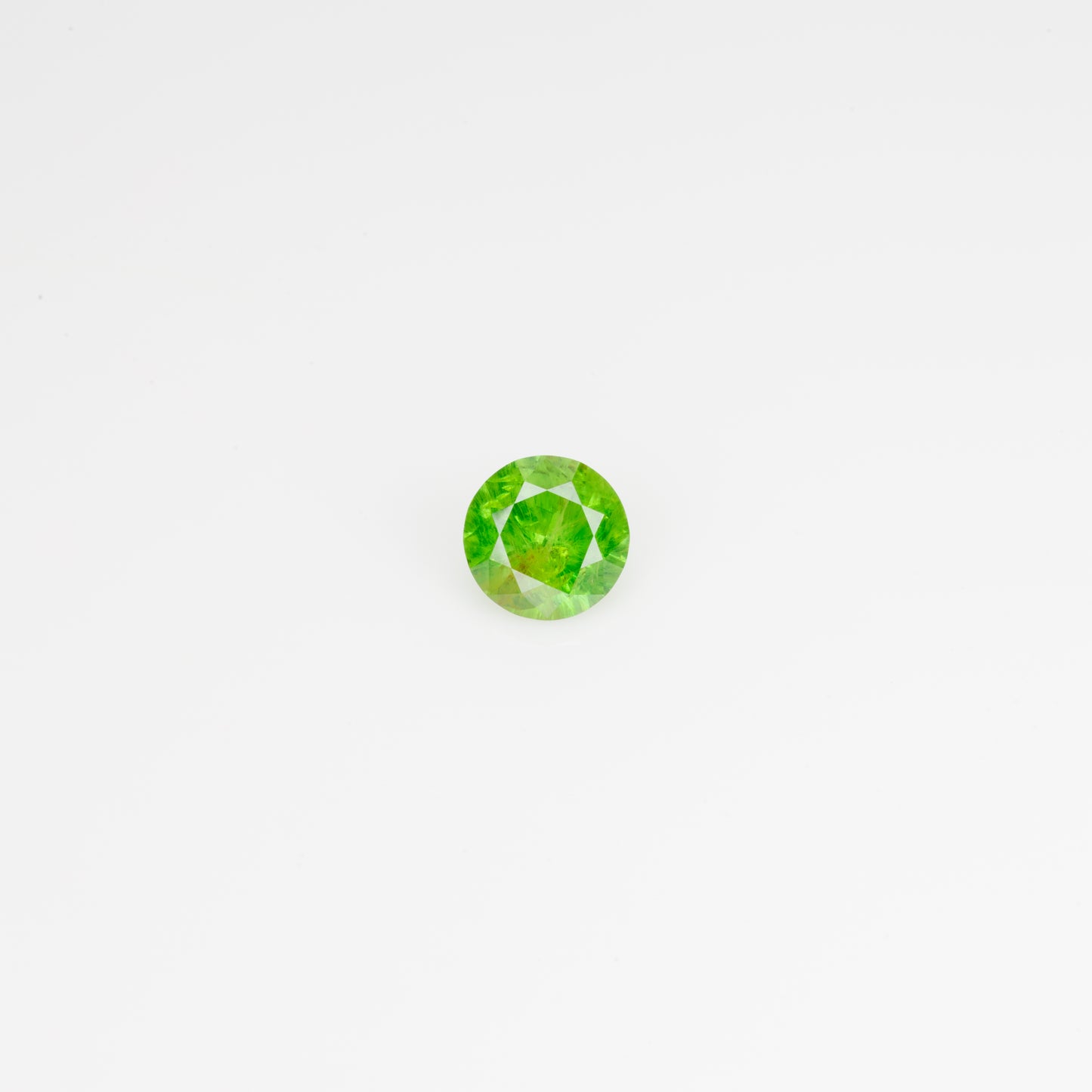 0.5 ct, Faceted Russian Demantoid with bissolite inclusions