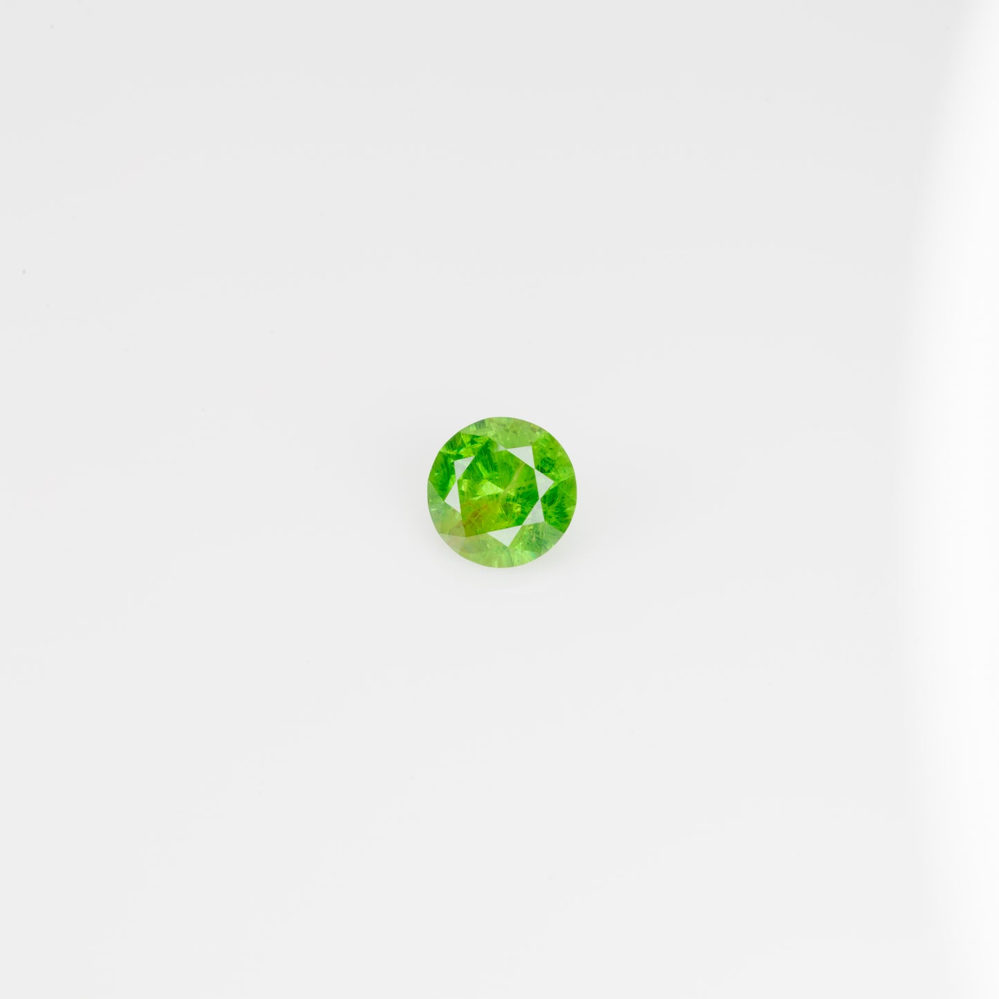 0.5 ct, Faceted Russian Demantoid with bissolite inclusions