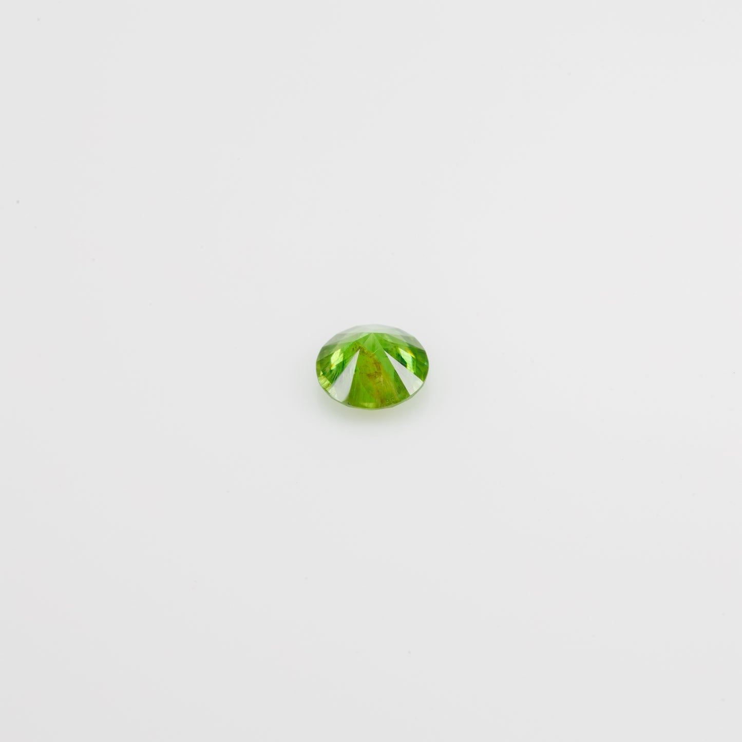 0.5 ct, Faceted Russian Demantoid with bissolite inclusions