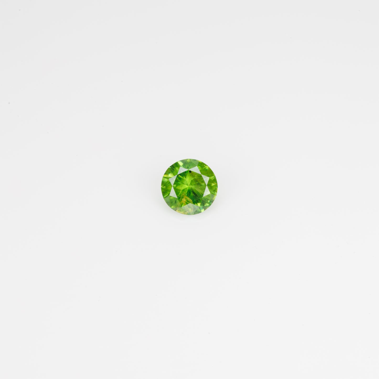 0.44 ct, Faceted Russian Demantoid with bissolite inclusions