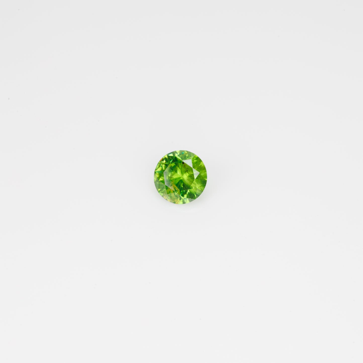 0.44 ct, Faceted Russian Demantoid with bissolite inclusions