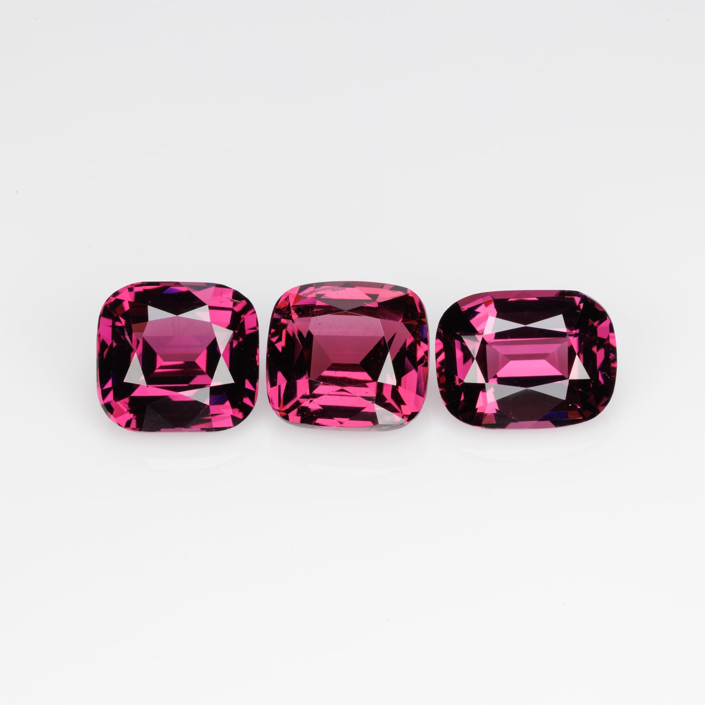 10 cts, Faceted rhodolite garnet cushion set the pair's