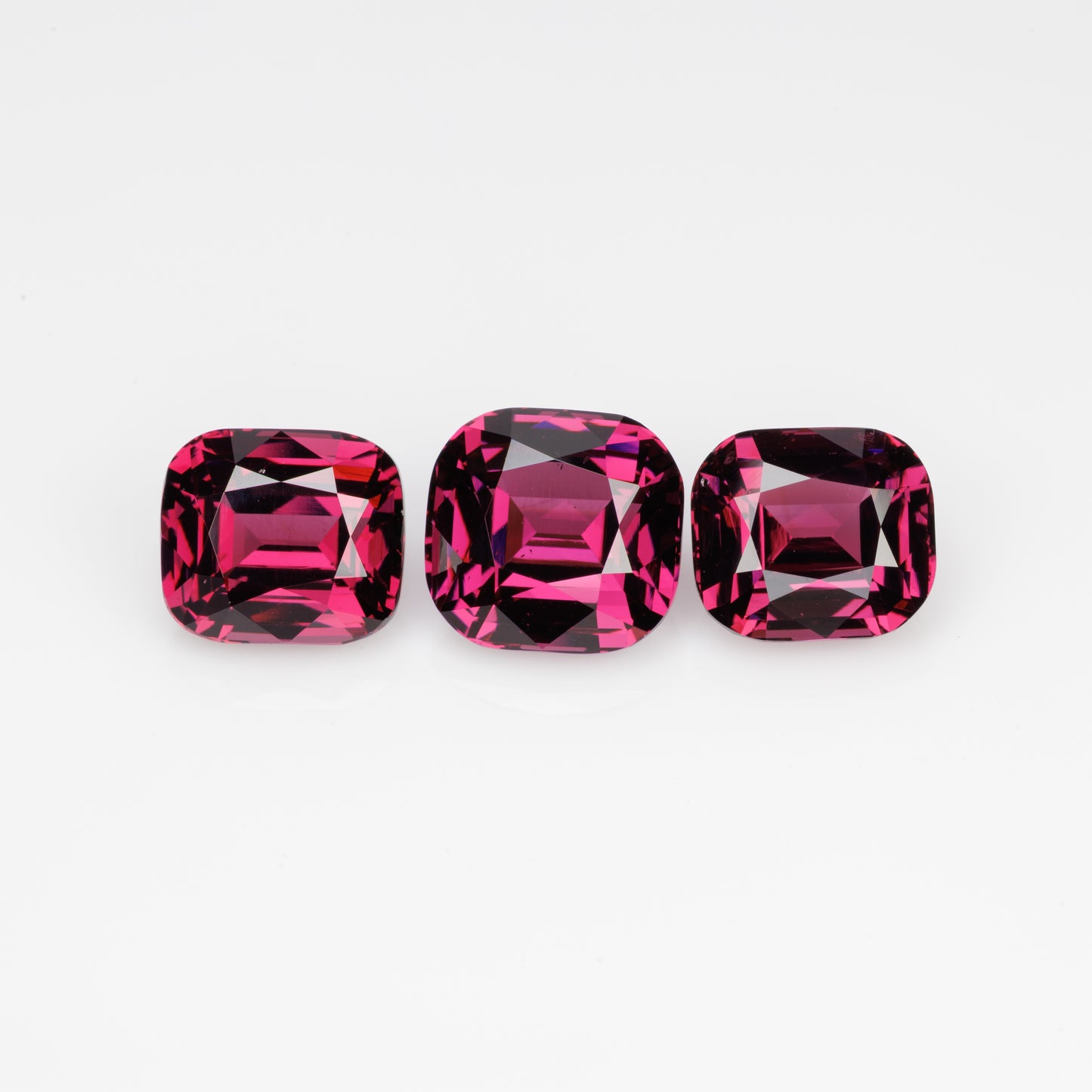 10.5 cts, Faceted rhodolite garnet cushion set the pair's